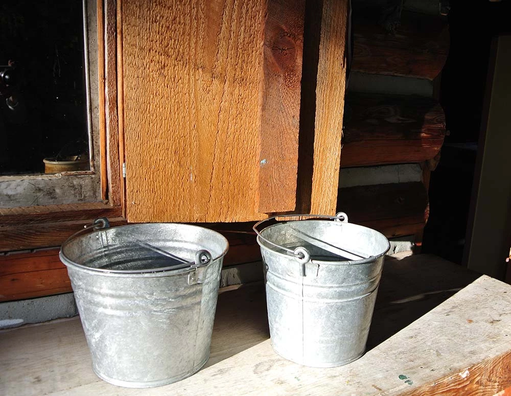 Image of two buckets that are used for the cabin's water source.